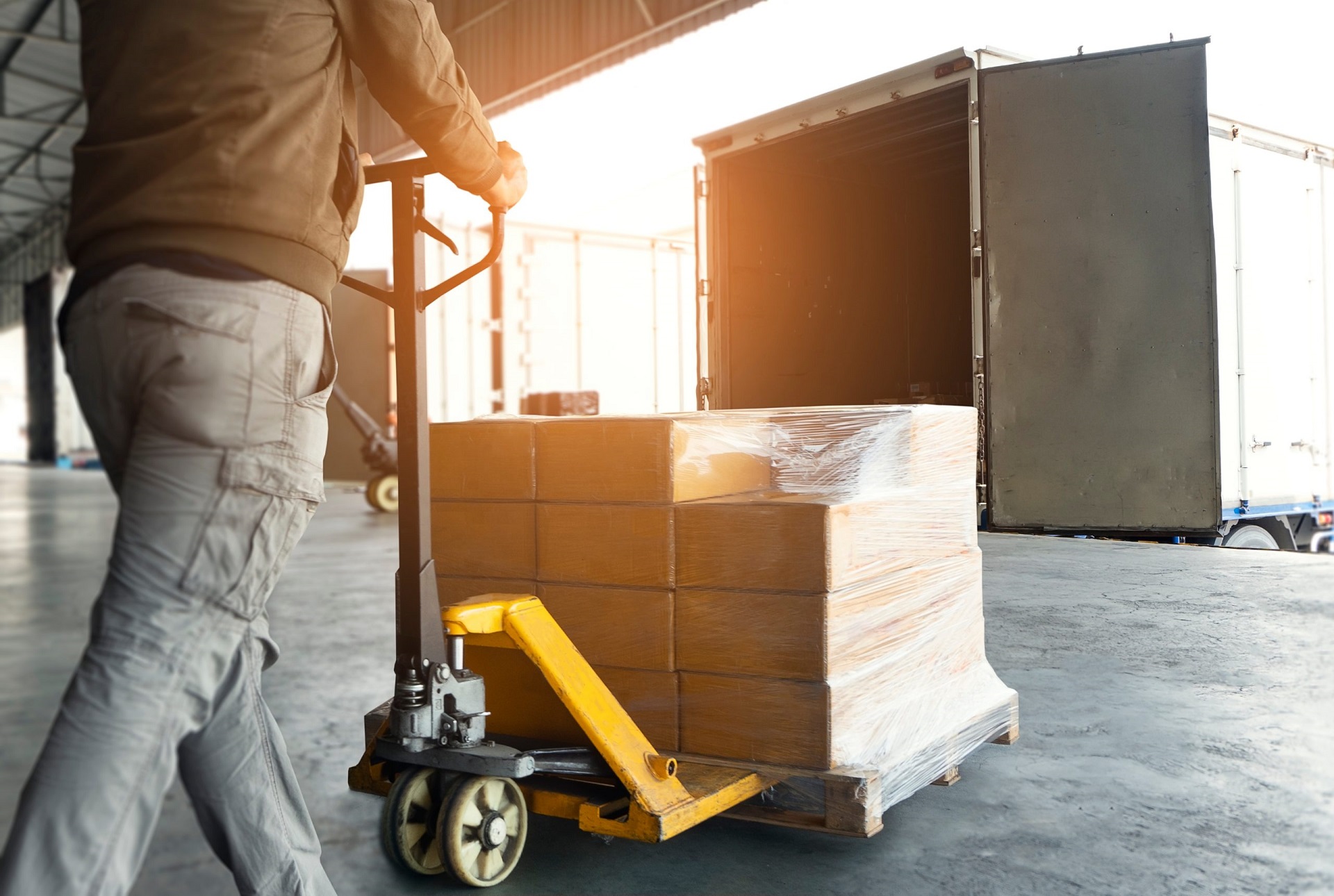 Workers Unloading Packaging Boxes on Pallets into The Cargo Container Trucks. Loading Dock. Shipping Warehouse. Delivery. Shipment Goods. Supply Chain. Warehouse Logistics Cargo Transport.